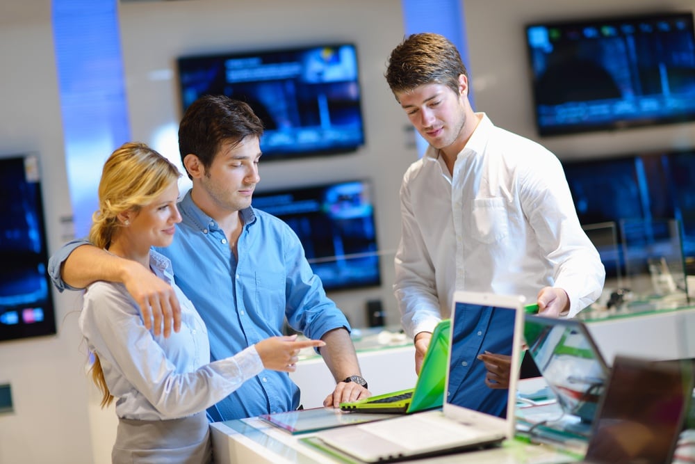 Young couple in consumer electronics store looking at latest laptop, television and photo camera-1