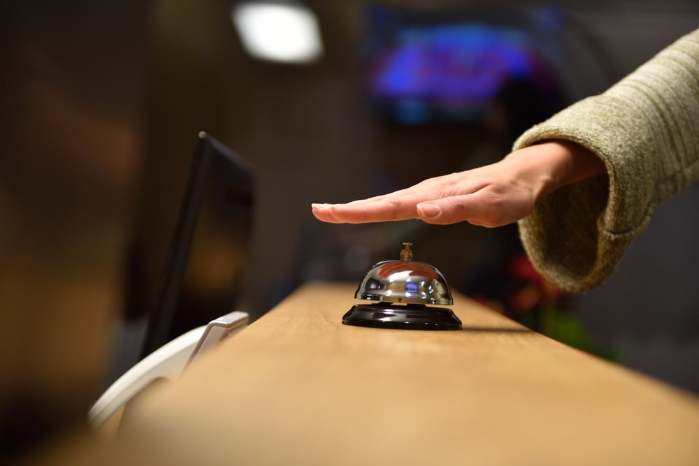 business woman at the reception of a hotel checking in